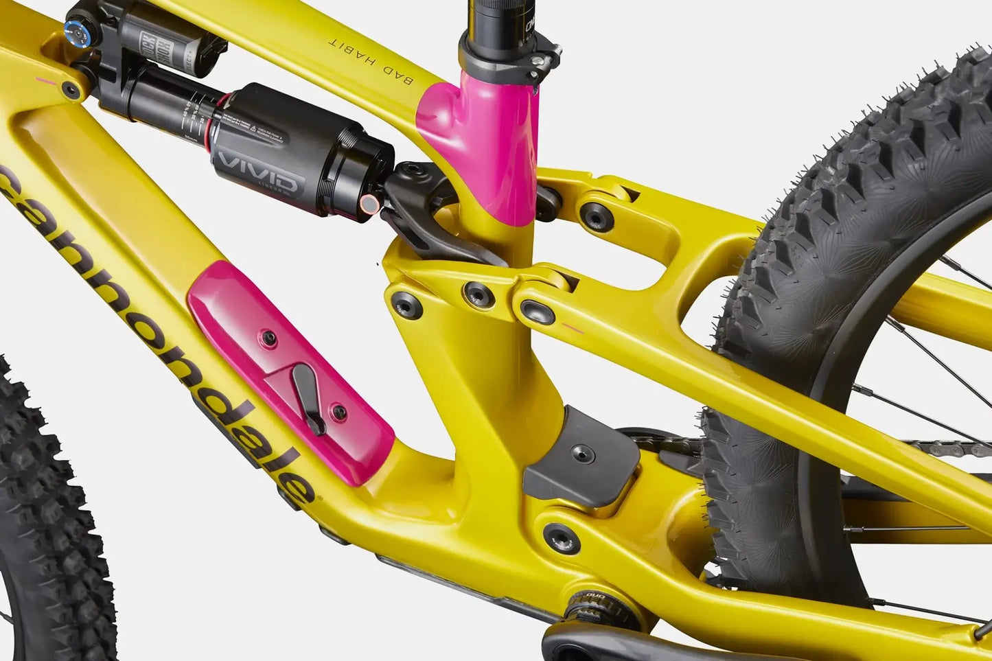 Cannondale Bad Habit 2 PYW close-up of suspension system and frame details in vibrant yellow and pink.