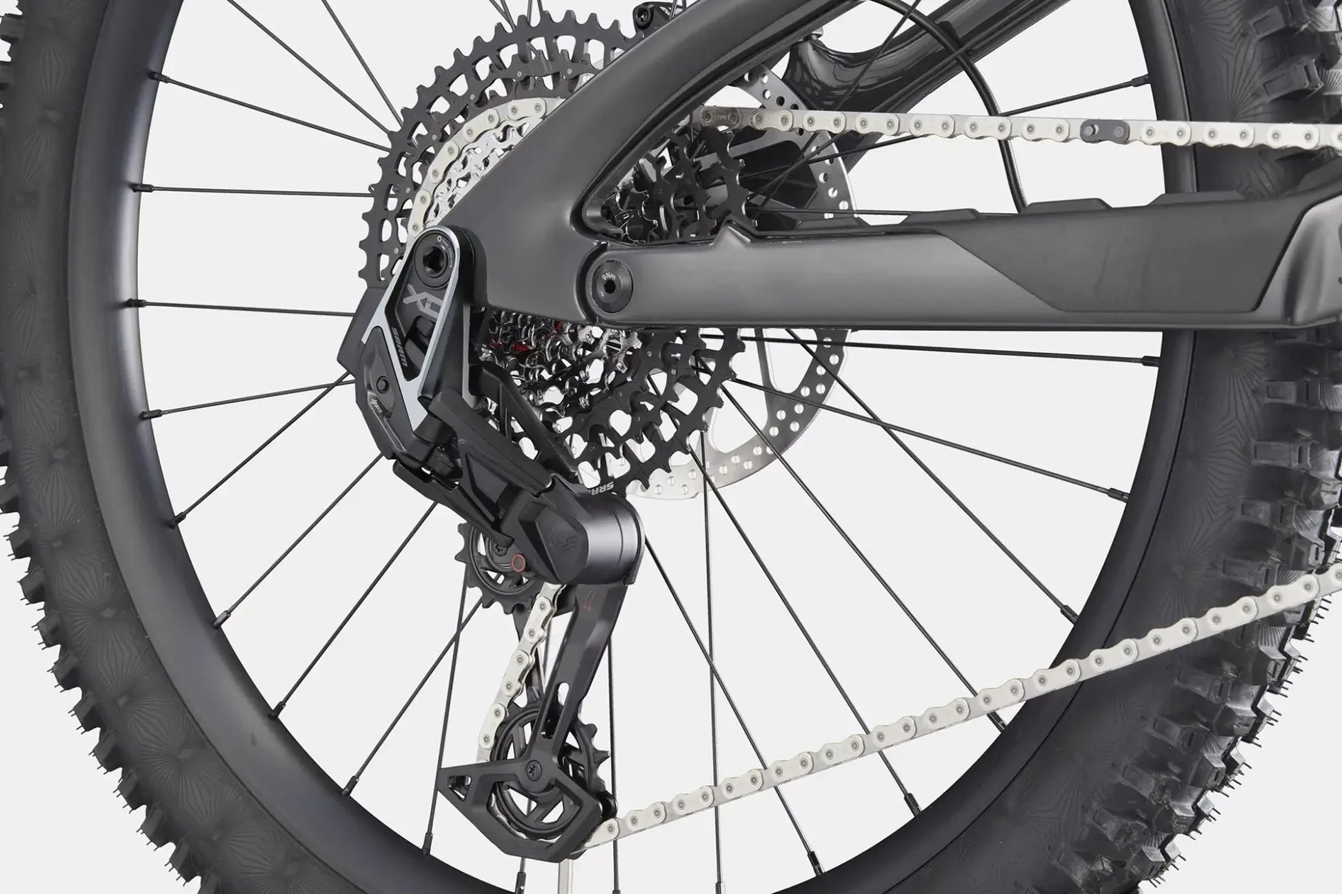 Cannondale Bad Habit 1 RAW rear derailleur and wheel close-up showcasing bike's advanced design and performance.