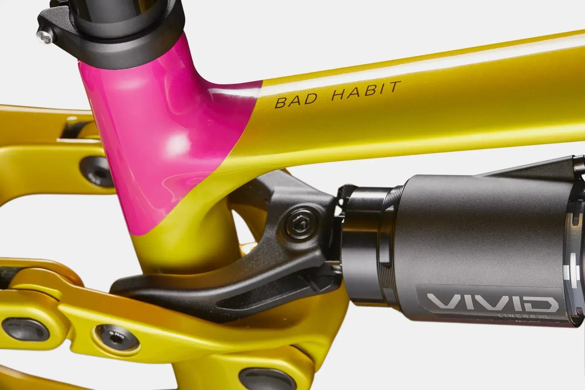 Cannondale Bad Habit 2 PYW mountain bike frame detail with vivid shock and vibrant yellow-pink paint.